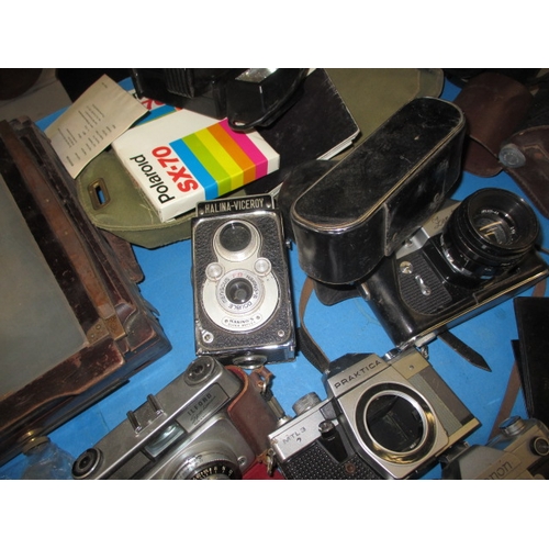 151 - A large quantity of vintage cameras and accessories, to include plate cameras and examples by Canon ... 