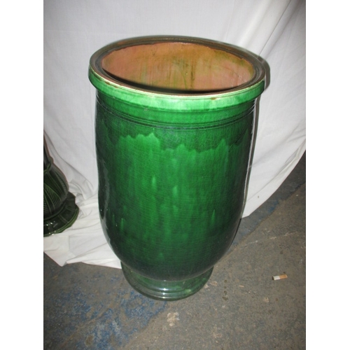 168 - A large green glazed garden plant pot 62cm high and a West German jardinière on stand, both in useab... 