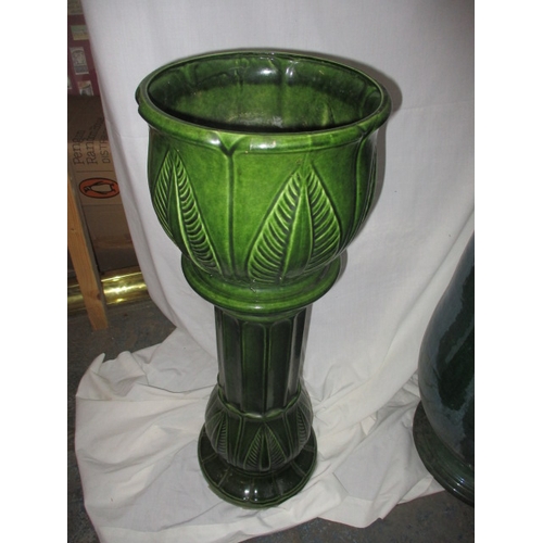 168 - A large green glazed garden plant pot 62cm high and a West German jardinière on stand, both in useab... 