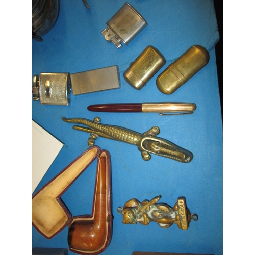 184 - A parcel of miscellaneous collectables, to include lighters, coins and a clock, all in used conditio... 