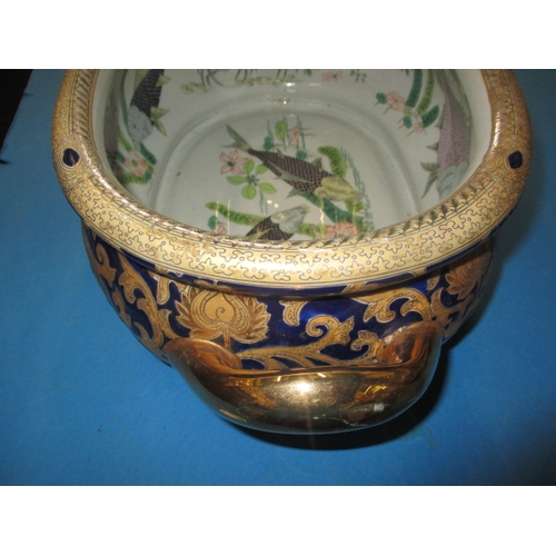 190 - A vintage ceramic oriental style fish bowl, with decorative interior and gilt blue outside decoratio... 