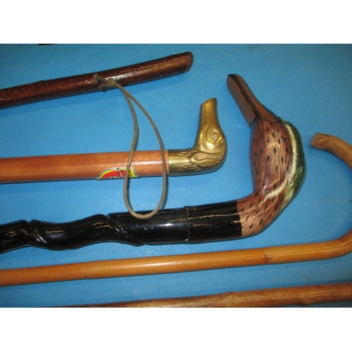 212 - A parcel of vintage walking sticks and a parasol, some with silver mounts, all in used condition