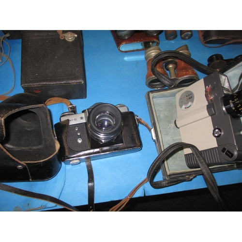 214 - An assortment of vintage cameras and binoculars, all in used condition and not tested as to function