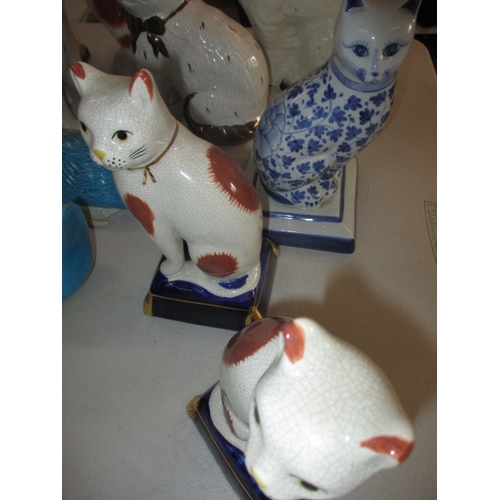 222 - A quantity of ceramic figures, to include Staffordshire mantle dogs and cats. All in pre-owned condi... 