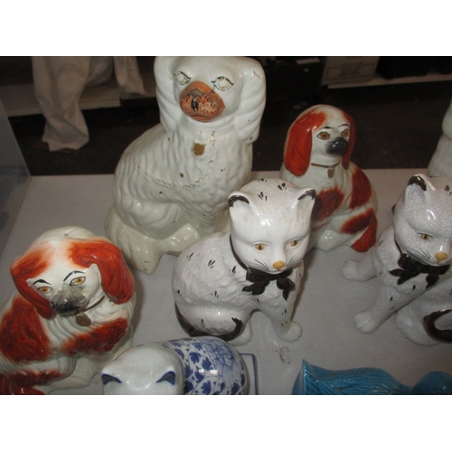 222 - A quantity of ceramic figures, to include Staffordshire mantle dogs and cats. All in pre-owned condi... 