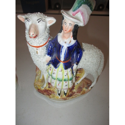 227 - A pair of 19th Century Staffordshire mantle figures of shepherd and sheep. Age related marks