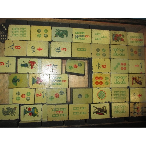 244 - A vintage Mah-Jong set in box, tiles are slate with lithographic images, in used condition and belie... 
