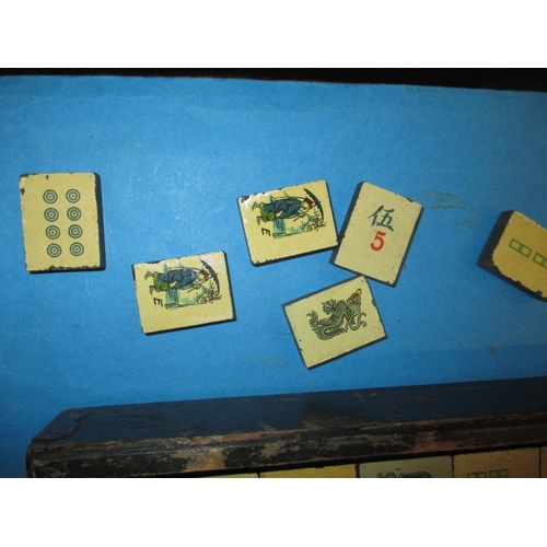 244 - A vintage Mah-Jong set in box, tiles are slate with lithographic images, in used condition and belie... 