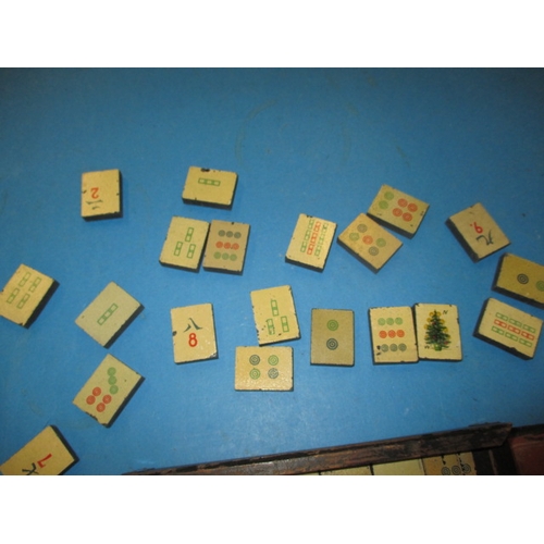 244 - A vintage Mah-Jong set in box, tiles are slate with lithographic images, in used condition and belie... 