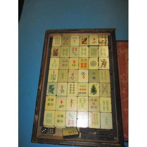 244 - A vintage Mah-Jong set in box, tiles are slate with lithographic images, in used condition and belie... 