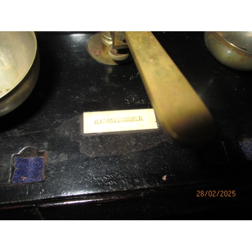 259 - Two sets of laboratory scales, one in glazed case. Both with part sets of weights. In used condition