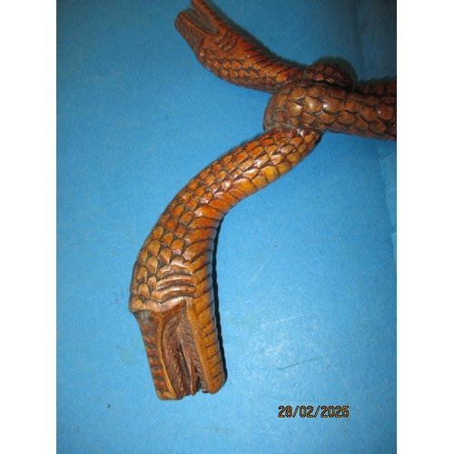 264 - A vintage walking cane, carved wood to simulate snake skin. Approximate length 90cm