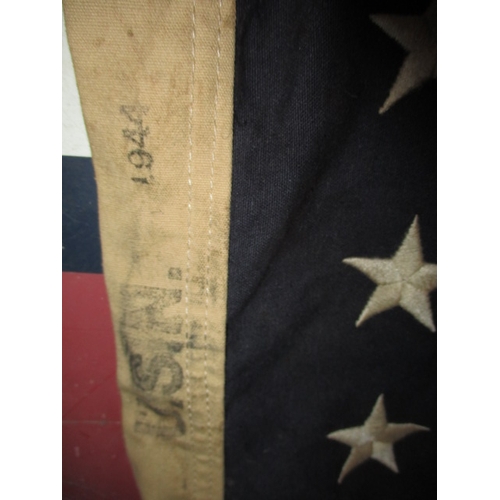 270 - A vintage USA Stars and stripes flag, the edge marked USN and dated1944, approx. size 146x82cm, havi... 