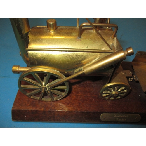 276 - A brass model of Stephenson’s Rocket locomotive on wood base, approx. length 33cm in used condition