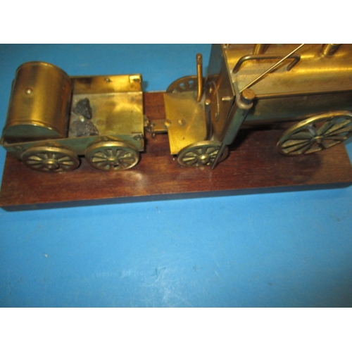 276 - A brass model of Stephenson’s Rocket locomotive on wood base, approx. length 33cm in used condition