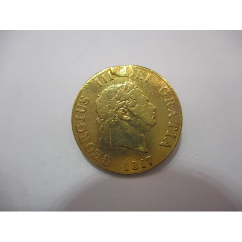 194 - A George III gold half sovereign, dated 1817, a circulated coin with fine definition of features, ni... 