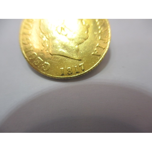 194 - A George III gold half sovereign, dated 1817, a circulated coin with fine definition of features, ni... 