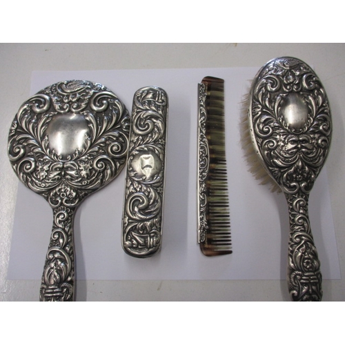 An antique 4 piece silver backed dressing table set, in good pre-owned condition