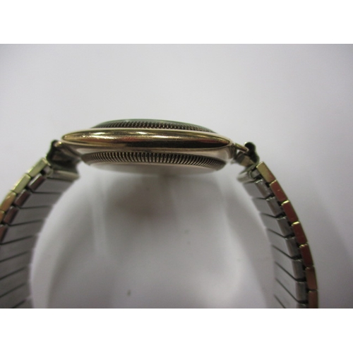 162 - A c1930s Rolex Oyster gold cased cushion wrist watch with later expanding bracelet, runs well when w... 