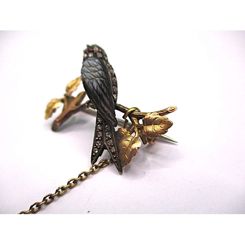 145 - An antique brooch of a song bird on a branch, yellow metal and gem set, electronically tested as dia... 