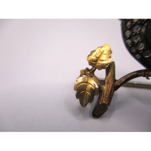 145 - An antique brooch of a song bird on a branch, yellow metal and gem set, electronically tested as dia... 