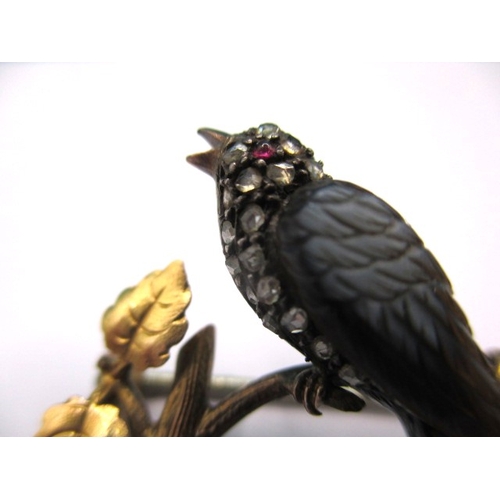 145 - An antique brooch of a song bird on a branch, yellow metal and gem set, electronically tested as dia... 
