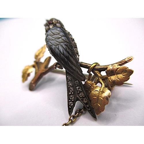 145 - An antique brooch of a song bird on a branch, yellow metal and gem set, electronically tested as dia... 