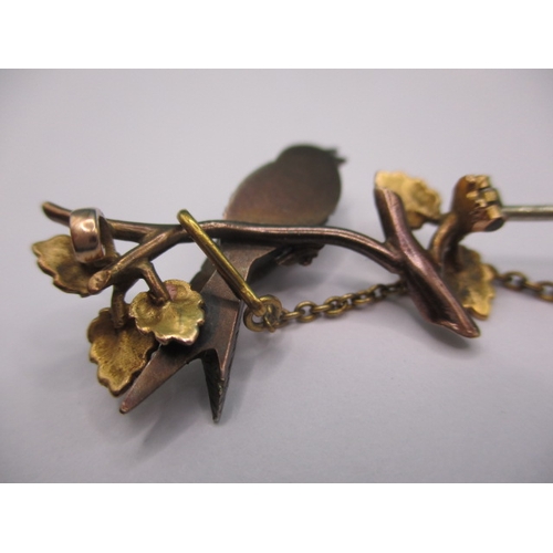 145 - An antique brooch of a song bird on a branch, yellow metal and gem set, electronically tested as dia... 