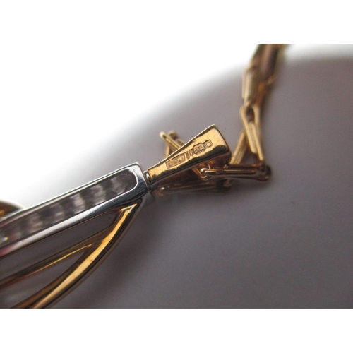 121 - A 750 yellow and white gold necklace and pendant with central row of diamonds, approx linear length ... 