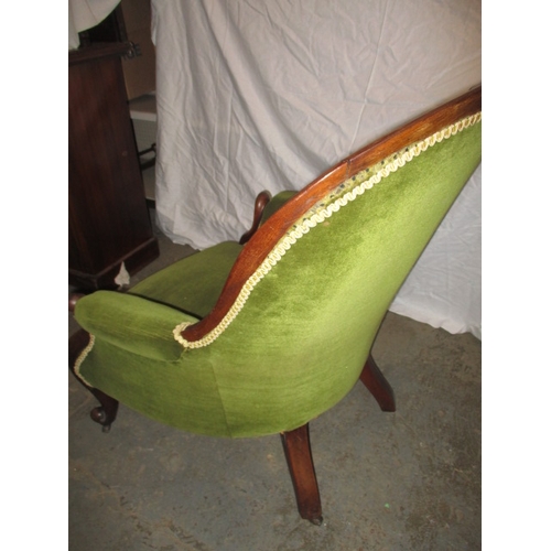 339 - A vintage green upholstered button back show wood parlour chair. In pre-owned condition with user re... 
