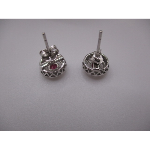 127 - A pair of 9ct white gold diamond and ruby earrings, in good pre-owned condition, approx gross parcel... 