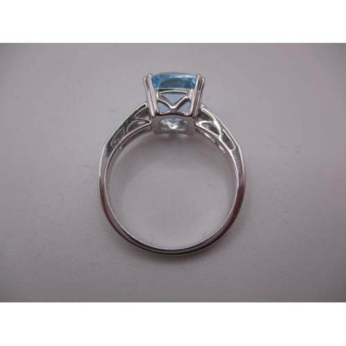 15 - An 18ct white gold diamond and aquamarine dress ring, in near unused condition, approx ring size ‘N’... 