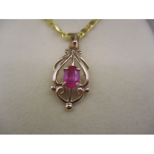 135 - A 9ct gold necklace pendant with central ruby on plated chain, in good useable pre-owned condition