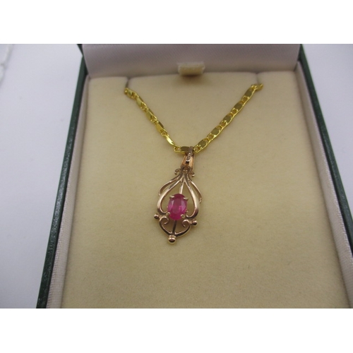 135 - A 9ct gold necklace pendant with central ruby on plated chain, in good useable pre-owned condition