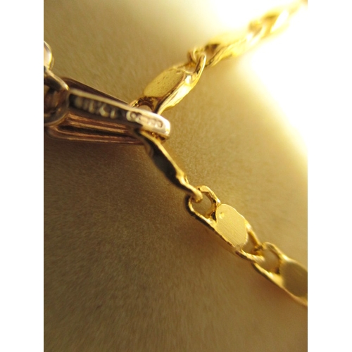 135 - A 9ct gold necklace pendant with central ruby on plated chain, in good useable pre-owned condition