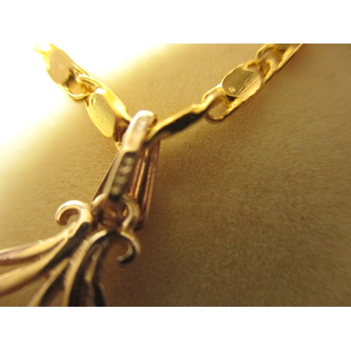 135 - A 9ct gold necklace pendant with central ruby on plated chain, in good useable pre-owned condition