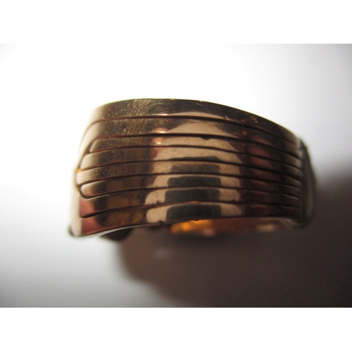 95 - A Saudi Arabian gold puzzle ring, comprising of 8 segments, in good pre-owned condition, approx ring... 