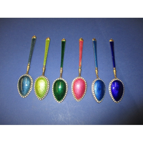 215 - A set of six 925 silver and enamel tea spoons, the pink one having the smallest sliver of enamel mis... 