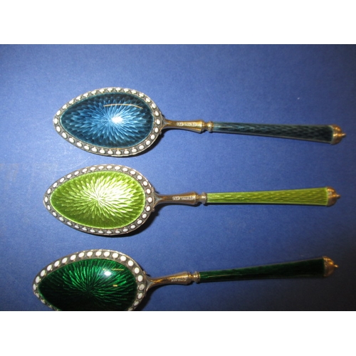 215 - A set of six 925 silver and enamel tea spoons, the pink one having the smallest sliver of enamel mis... 