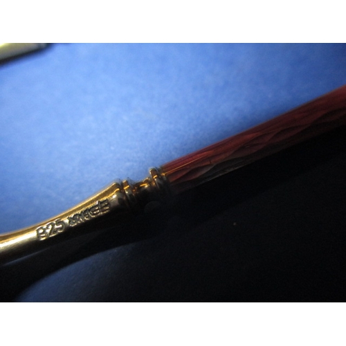 215 - A set of six 925 silver and enamel tea spoons, the pink one having the smallest sliver of enamel mis... 