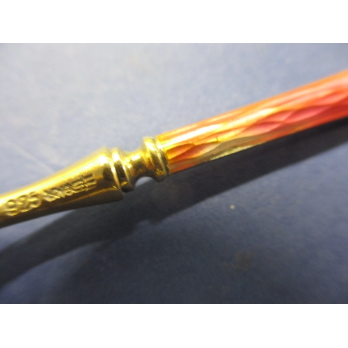 215 - A set of six 925 silver and enamel tea spoons, the pink one having the smallest sliver of enamel mis... 