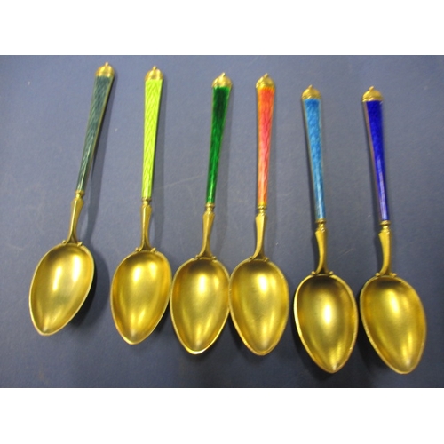 215 - A set of six 925 silver and enamel tea spoons, the pink one having the smallest sliver of enamel mis... 