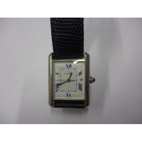 174 - A vintage silver cased Cartier tank watch, pre-owned with use related marks and not tested to functi... 