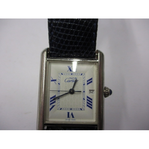 174 - A vintage silver cased Cartier tank watch, pre-owned with use related marks and not tested to functi... 