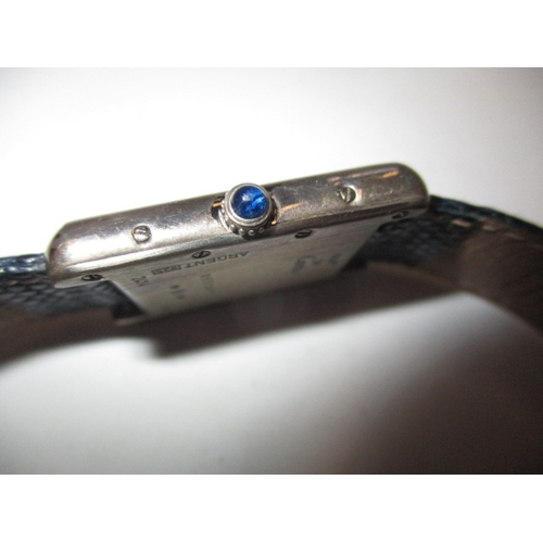 174 - A vintage silver cased Cartier tank watch, pre-owned with use related marks and not tested to functi... 