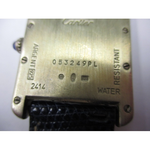 174 - A vintage silver cased Cartier tank watch, pre-owned with use related marks and not tested to functi... 