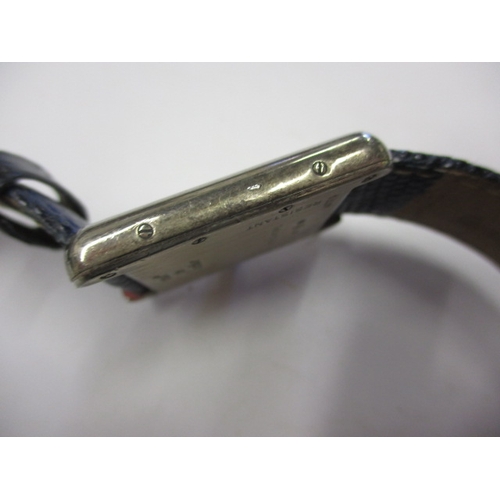 174 - A vintage silver cased Cartier tank watch, pre-owned with use related marks and not tested to functi... 