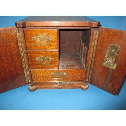 334 - An early 20th century oak smokers cabinet in the form of a bank safe, approx height 32cm, use relate... 