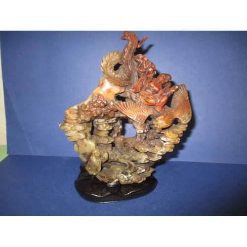 An oriental soapstone carving on wood base, approx height 18cm, in good pre-owned condition