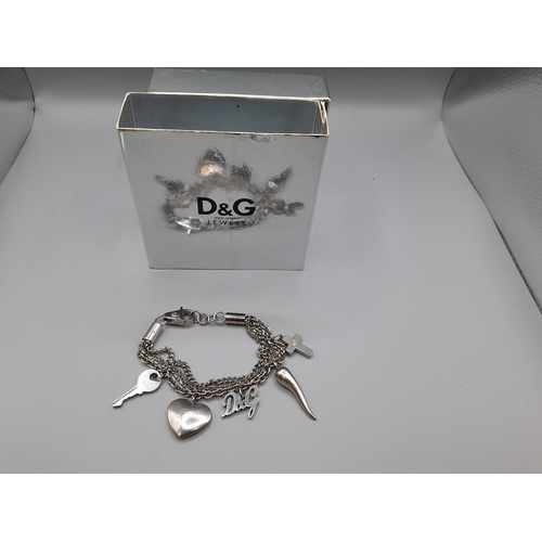 A Dolce & Gabbana bracelet, numerous D&G charms, in original box